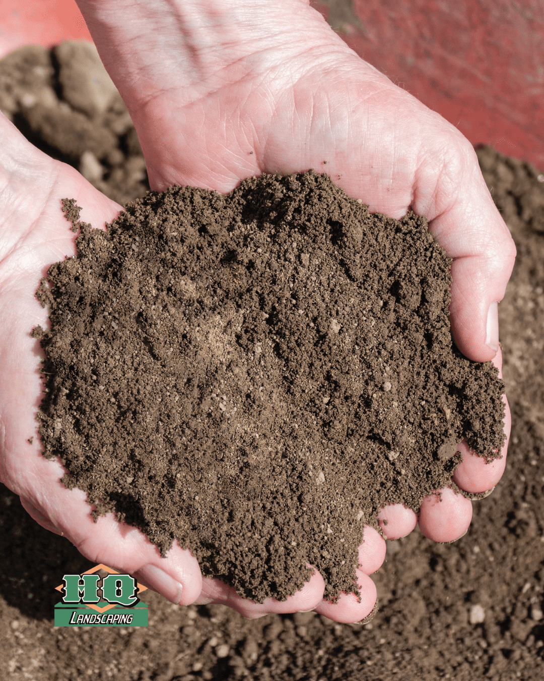 topsoil HQ Hands holding a sample of screened topsoil from HQ Landscaping in Central Connecticut, showing fine texture and rich organic quality ideal for gardening and landscaping projects.